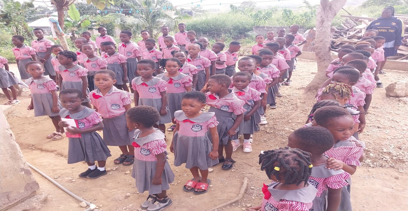 Pupils in class, one child raising a hand